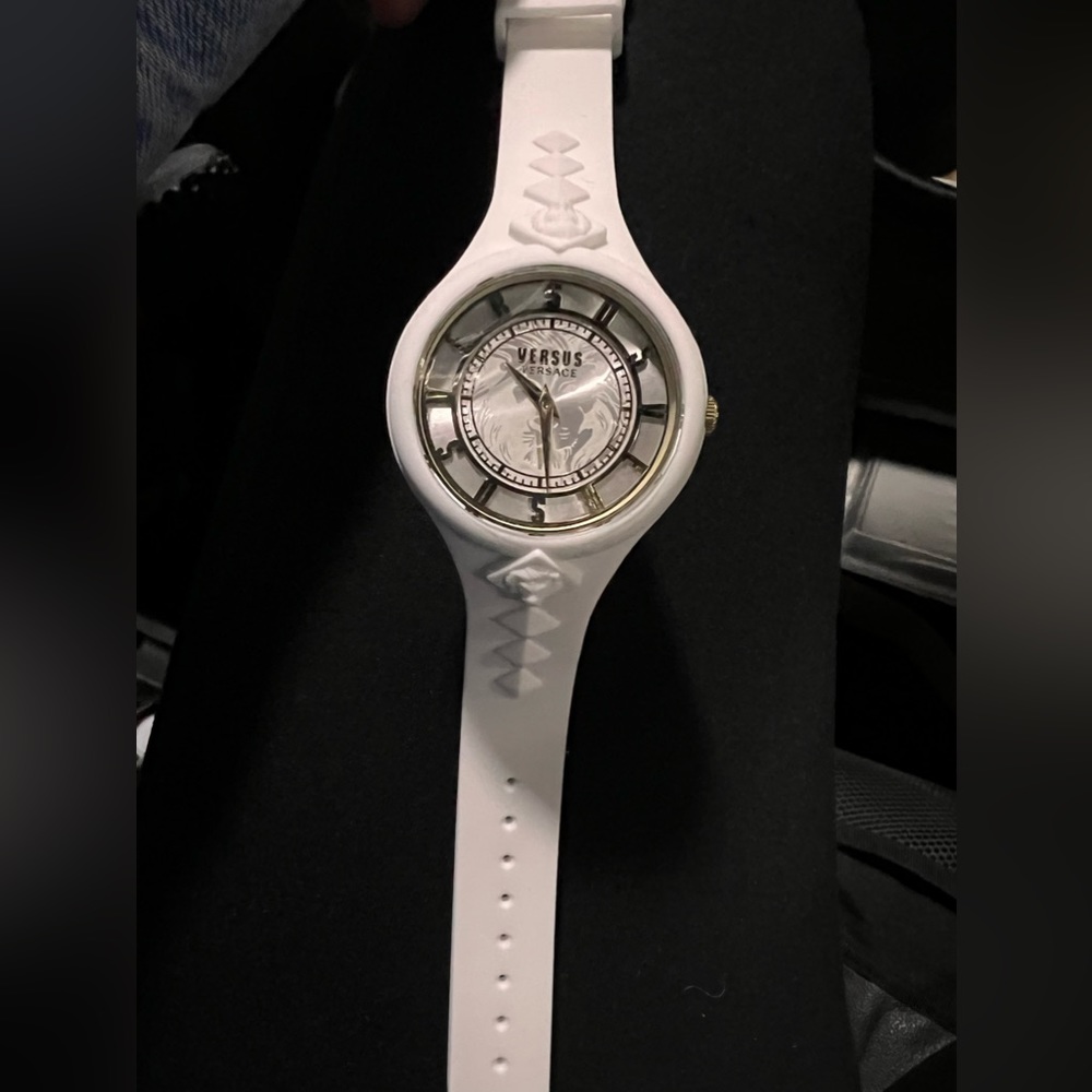 White Versace watch with gold face.